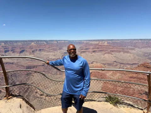 Derrick Doles in front of a large desert landscape
