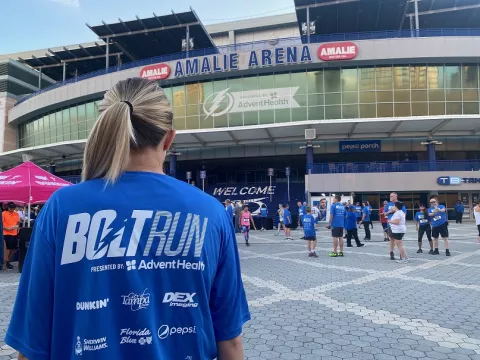 Bolt Run runner stands in front of Amalie Arena 