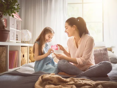 Mother and daughter share a loving card.