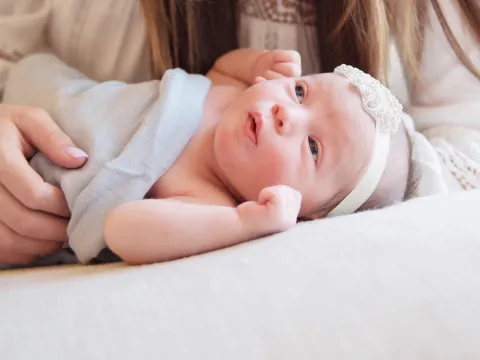 Mother with a newborn baby at home.