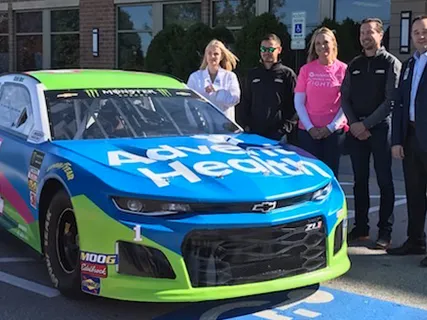 Kurt Busch and Kyle Larson visited cancer patients and  unveiled the No. 1 car accented in pink for breast cancer awareness 