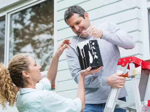 Volunteers painting a house.