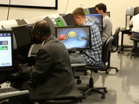 Professionals in a simulation in the Nicholson Center Simulation Lab.