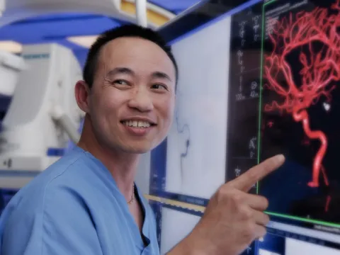 A nurse pointing his finger on the medical screen