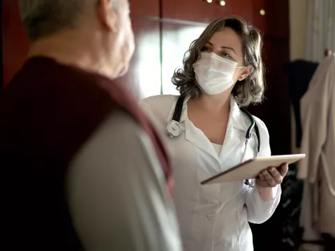 An older man talking to his doctor. 
