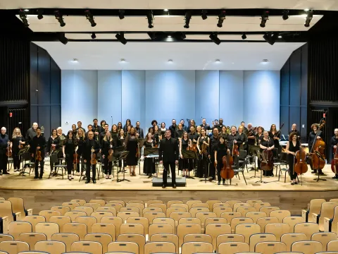AdventHealth Orchestra on an indoor stage.