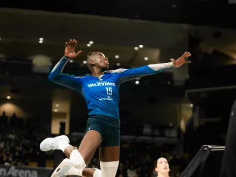 Orlando Valkyries player jumps into the air to hit a ball