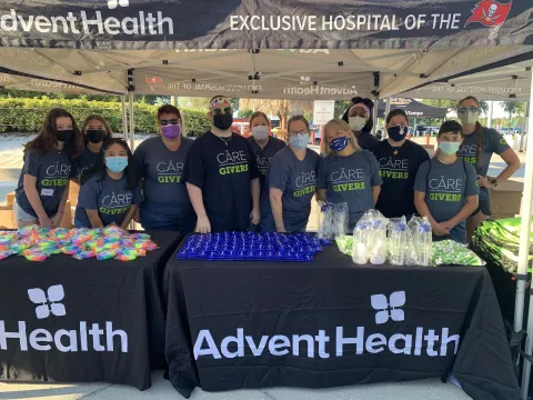 A group of masked volunteers posing for a photo