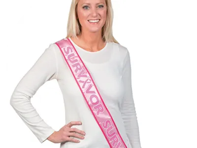 Woman wearing breast cancer survivor sash