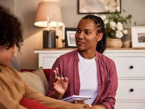 Mental health provider speaking to young client.
