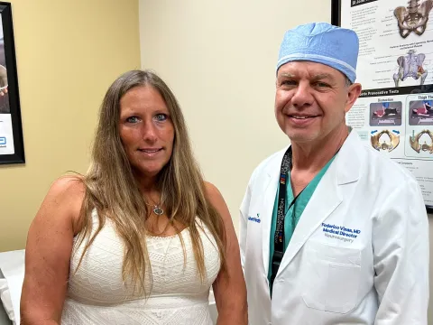 Dr. Federico Vinas and patient Sandi Potter share a moment together, highlighting her successful recovery made possible through exceptional clinical care and the AdventHealth Daytona Beach financial assistance program.