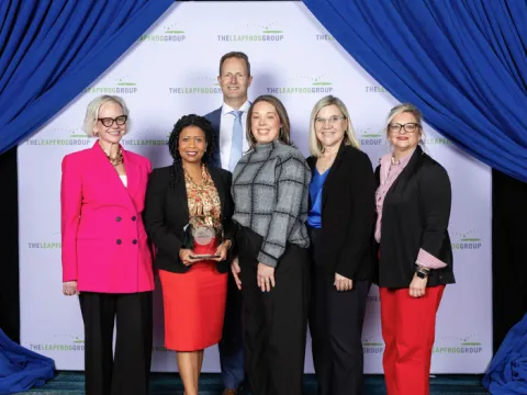 Group of people holding an award.