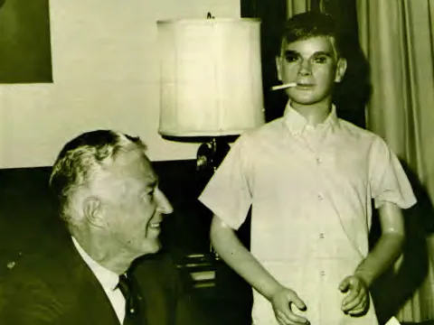 Smoking Sam looks over the shoulder of Wisconsin Governor Warren P. Knowles, who signs a proclamation designating the week of October 12 through 18 Stop Smoking Week in Wisconsin