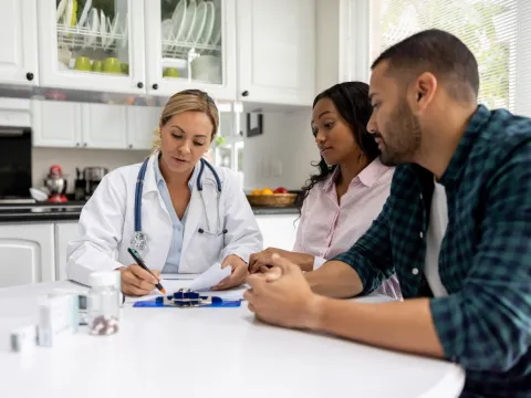 A couple talks to their doctor about fertility.