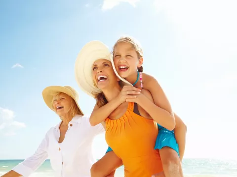 Tri-Generational family of women walking together on the beach