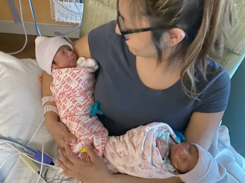 A mother holding her newborn child