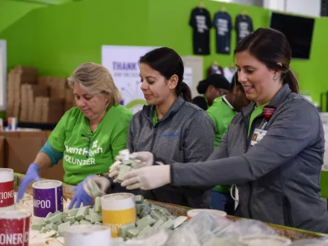 AdventHealth employees and volunteers working with bar soaps and conditioners