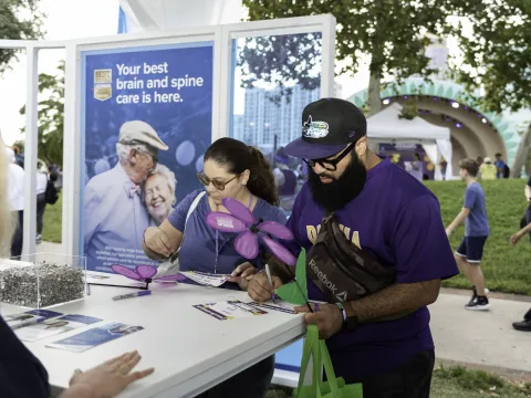 Participants write on paper at Walk to End Alzheimer's
