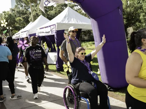 Woman in wheelchair crosses finish line at Walk to End Alzheimer's