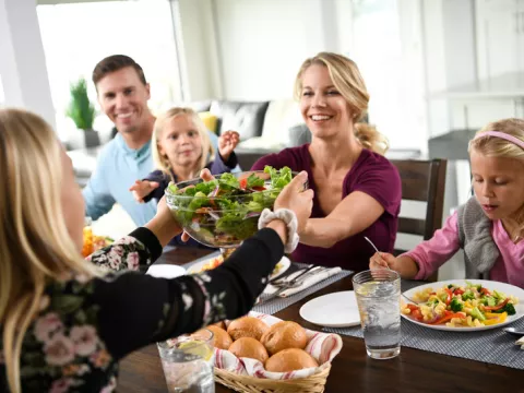 Family enjoys meal together at the dinner table