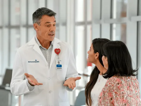 doctor speaking to two female patients