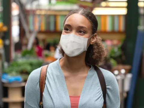 A woman wearing a mask in public.