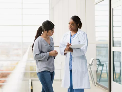 Woman talking with a doctor.