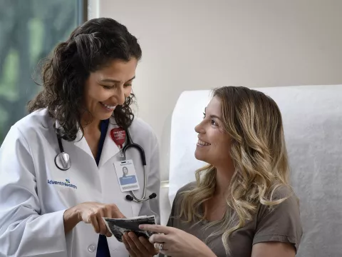 Young Woman talking to her doctor in a patient room.