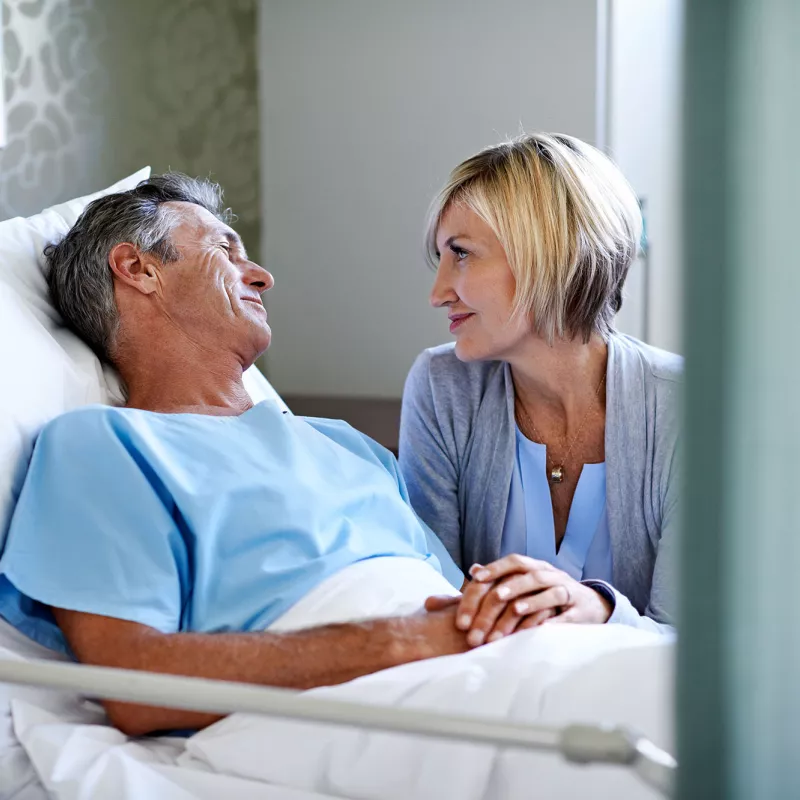 Woman visiting husband in the hospital.