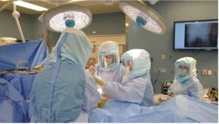 A surgical team, led by Dr. A.J. Clair, operates on Jean McMichael as part of Operation Walk USA 2024.