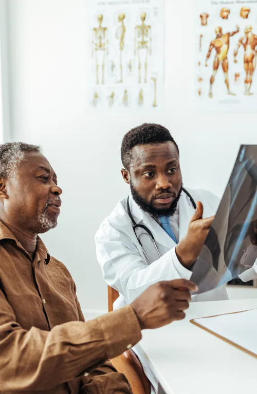Doctor showing man an X-Ray of his lungs