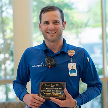 Chip Seagle holds his 911 Telecommunications award.
