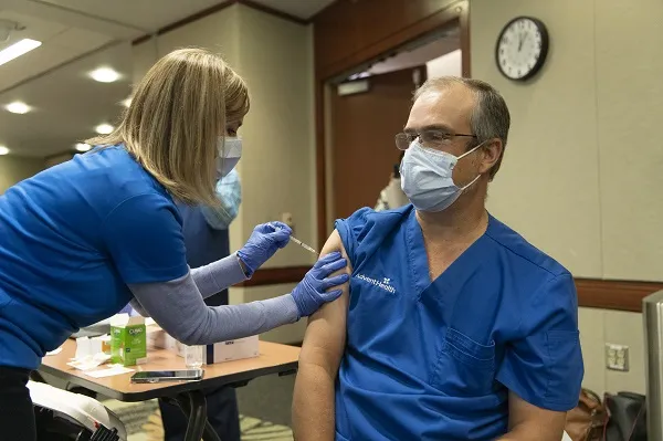 Dr. Oliveira receives a COVID-19 Vaccination at AdventHealth Orlando