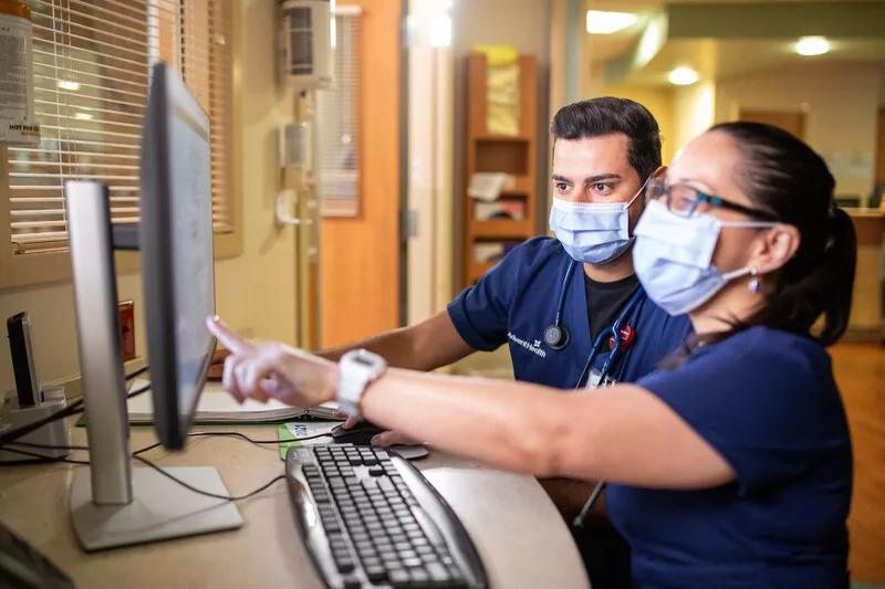 Caregivers look at screen