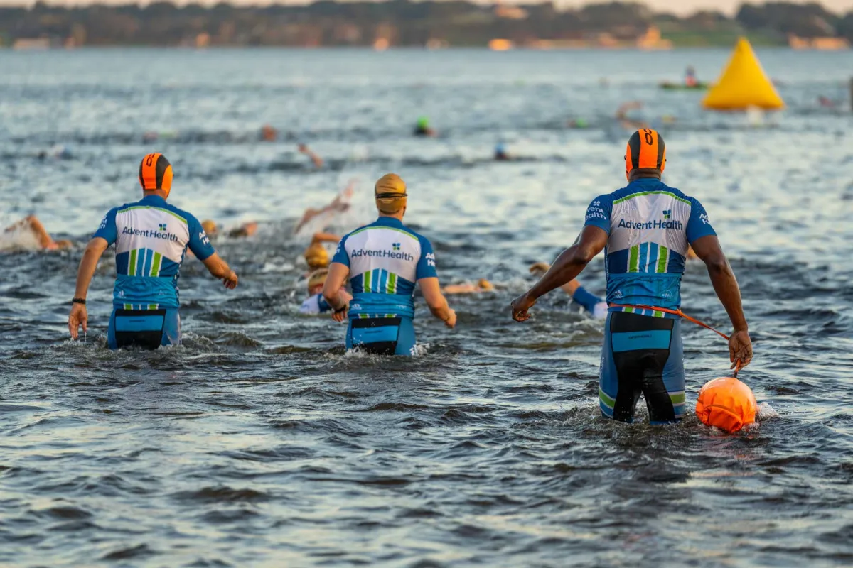 Triathlon participant, Chris Nikic, and his physical therapist, Trevor Hicks, getting in the water