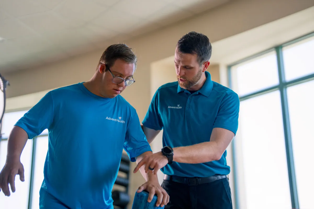 Chris Nikic being instructed by his physician, Trevor Hicks.