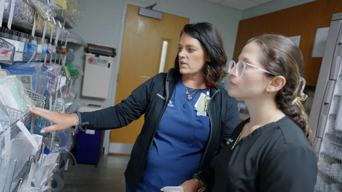 Dawn White, RN, senior nurse manager, ICU/PCU, and Franchesca Gonzalez, a junior at UCF in the nursing program discuss patient care in the ICU.