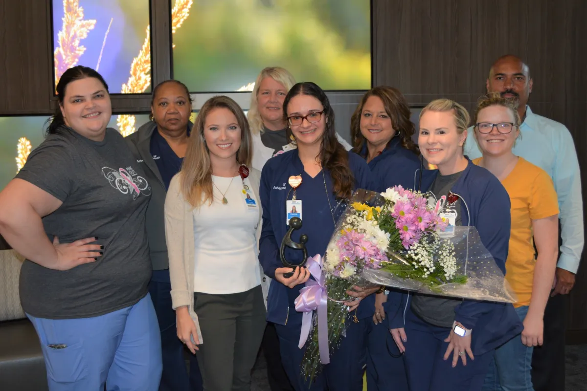 Group of people holding flowers.