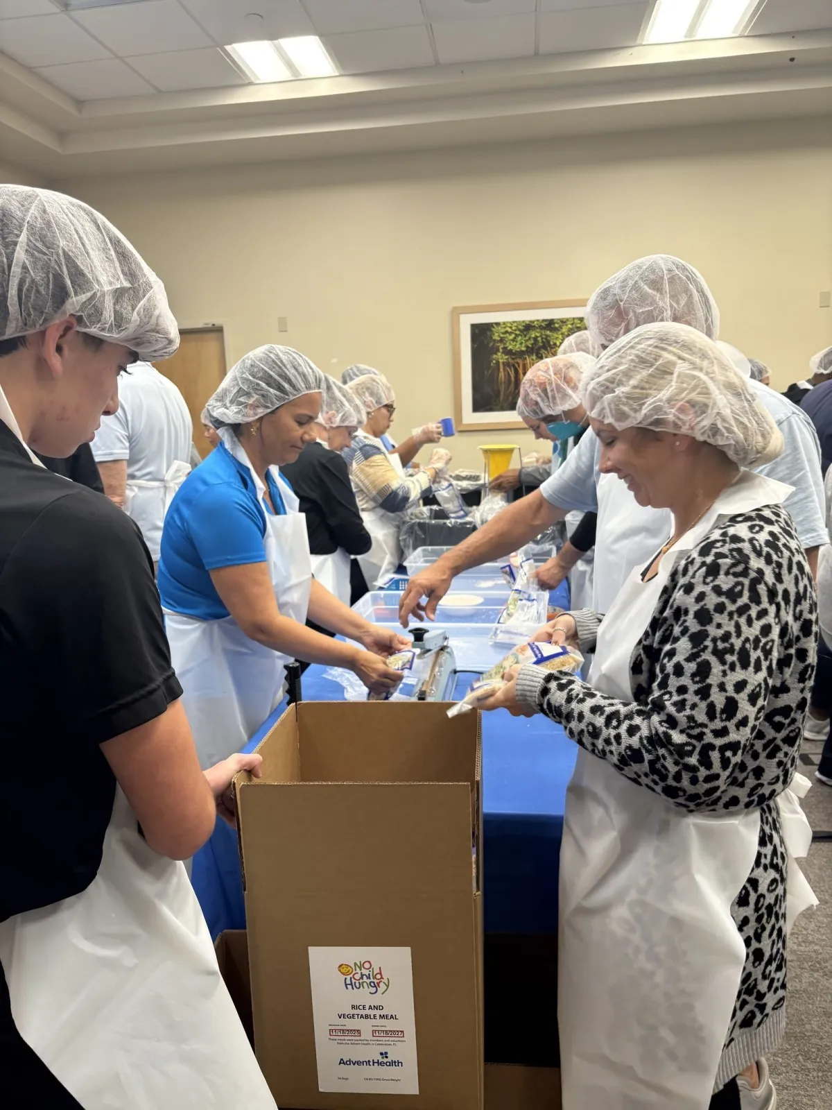 Team members pack meals for Jamaican residents.