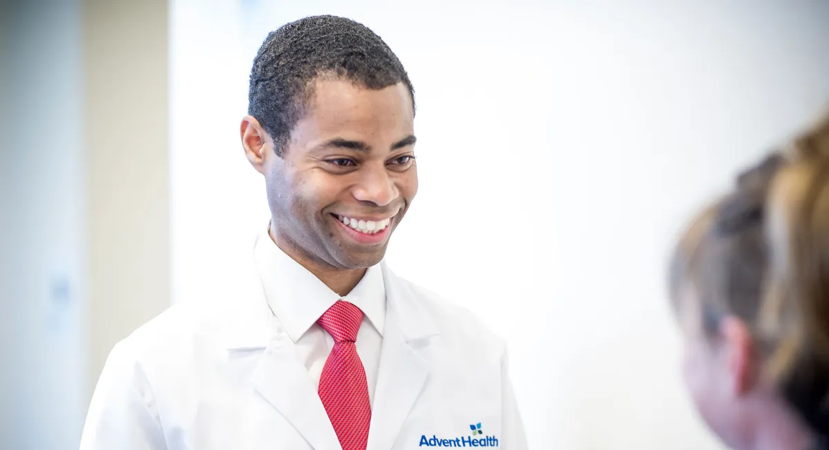 Doctor Carl Lokko smiling at a pediatric patient