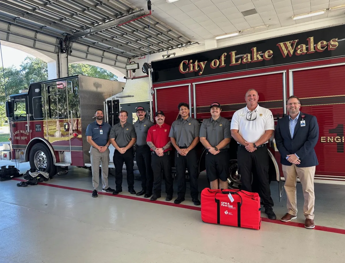 AdventHealth Heart of Florida leaders with Lake Wales Firefighters and the donated CPR and First Aid Training Kit Kit