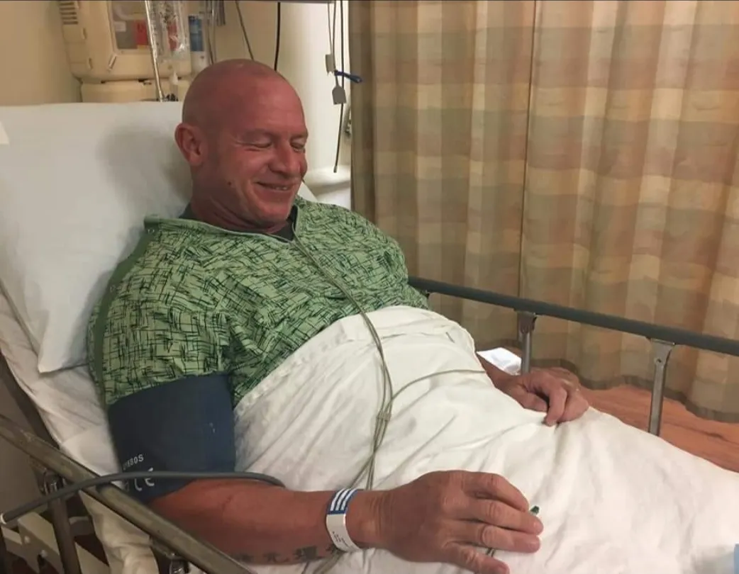 Stephen Wilson in a hospital bed