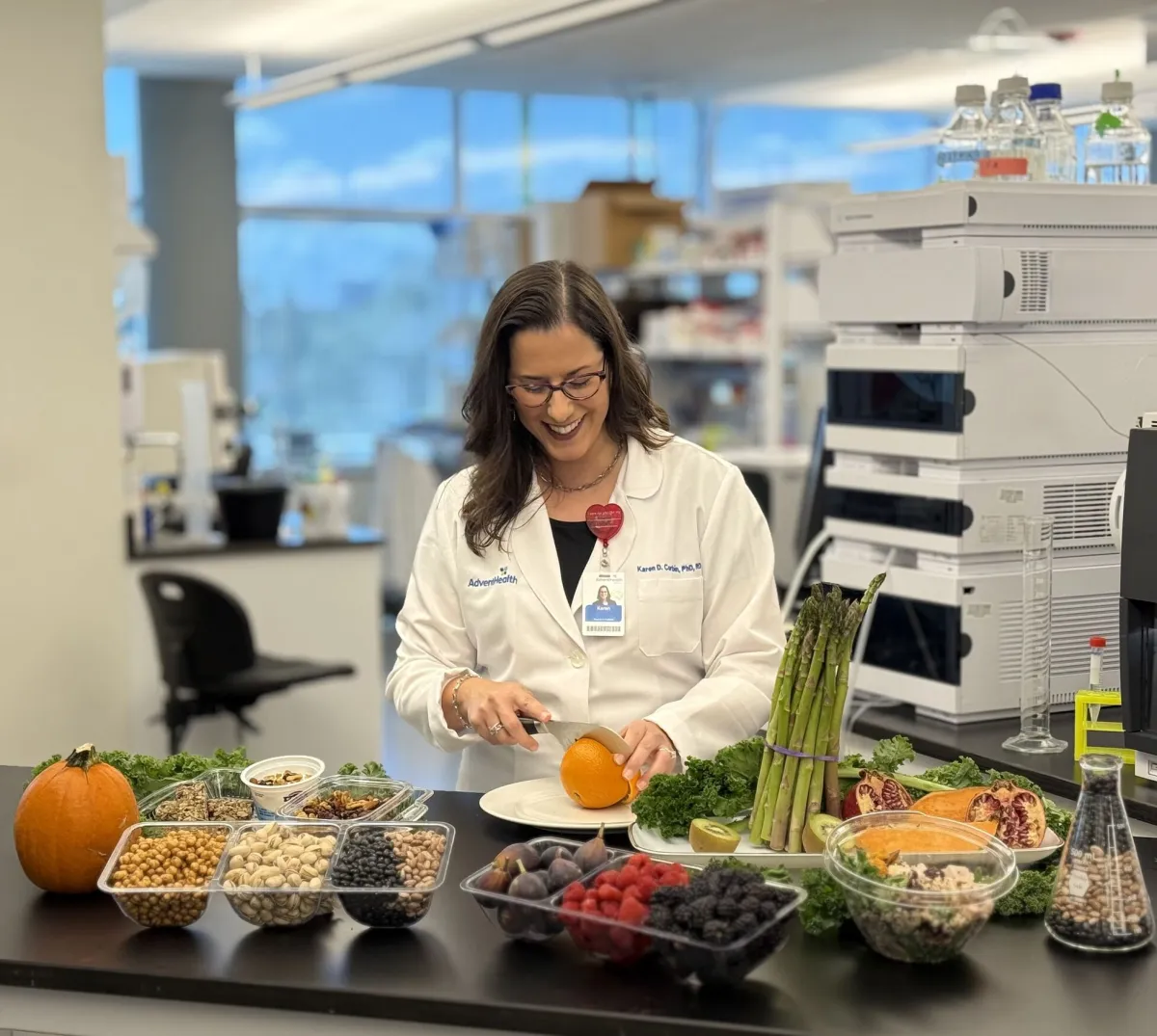 Karen Corbin, Ph.D., a nutrition scientist, slices an orange at the AdventHealth Translational Research Institute.