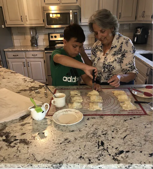 Sendros' mother making pastelitos with his son