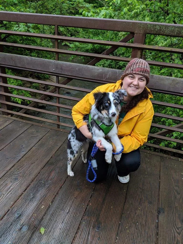 Woman and a dog on a bridge