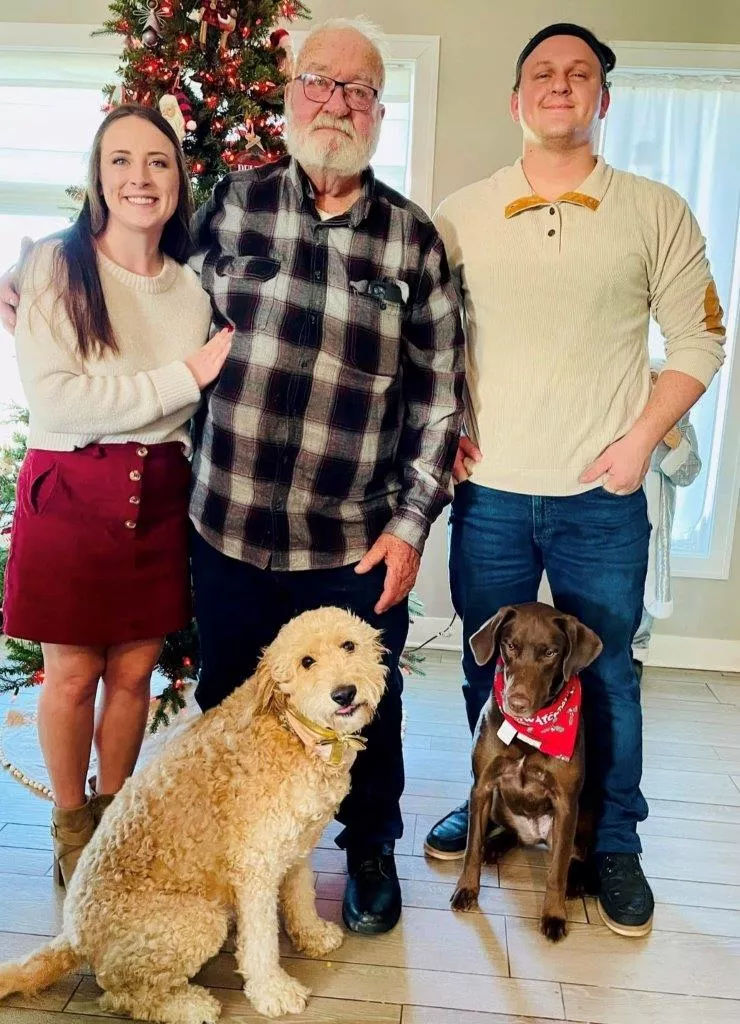 Woman with her brother, grandfather and dog. 