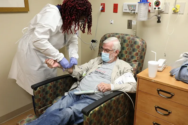 Nurse administers monoclonal infusion to patient