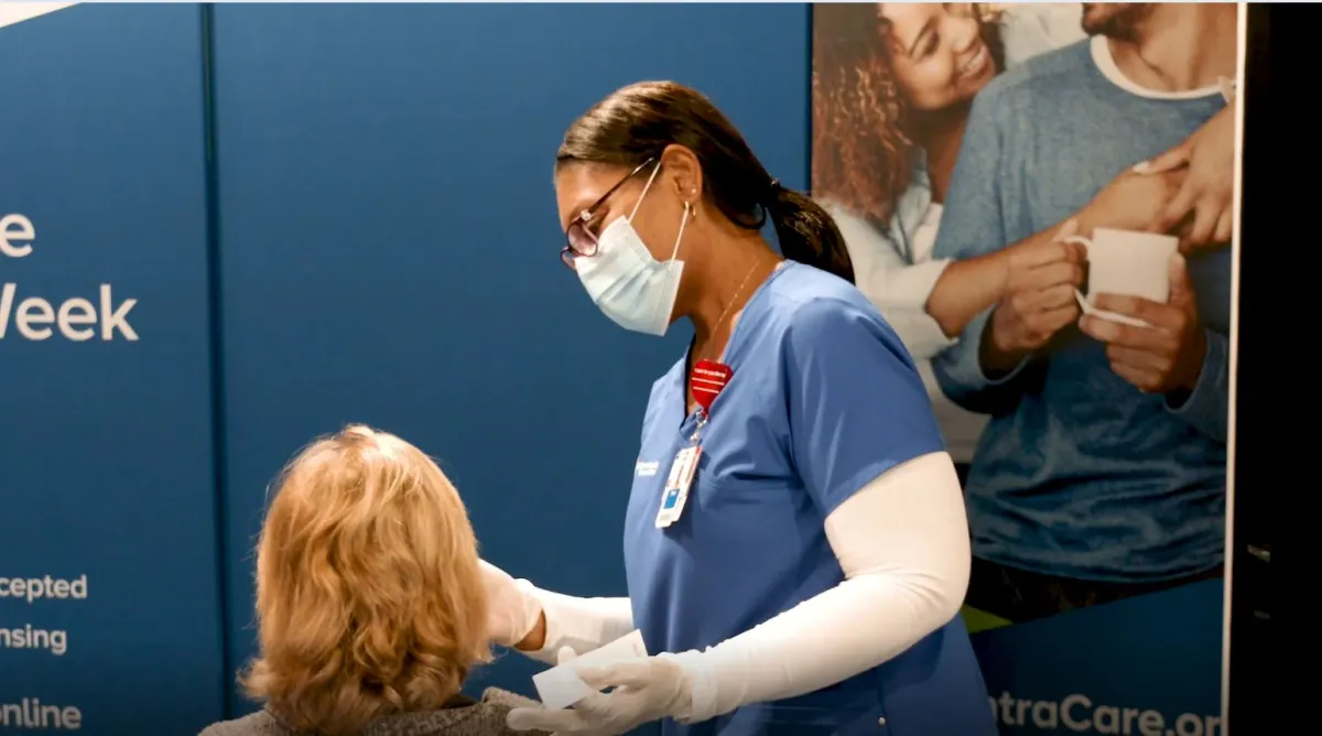 AdventHealth employee administers a COVID19 test to patient