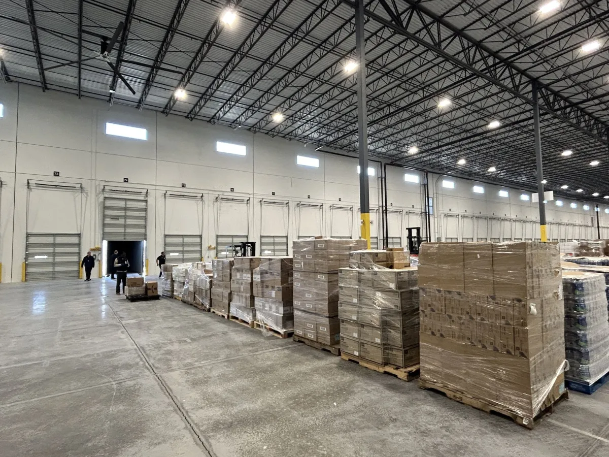 Packaged supplies on pallets sit in a warehouse.