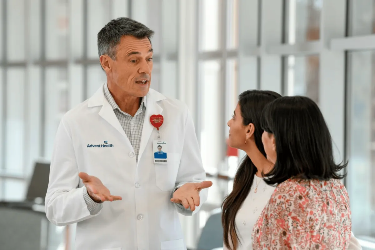 doctor speaking to two female patients